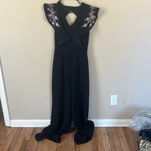 Black jumpsuit with floral embroidered sleeve detail, size XS